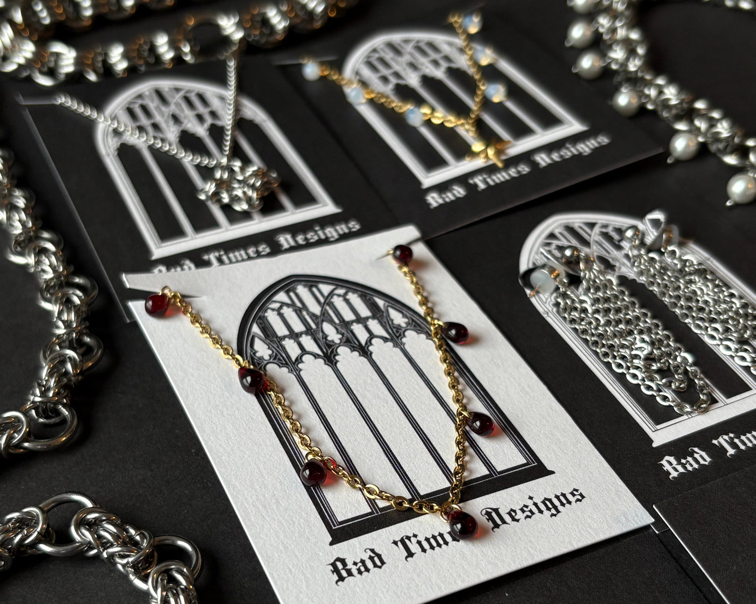 Close-up of silver necklaces with intricate designs on a black background
